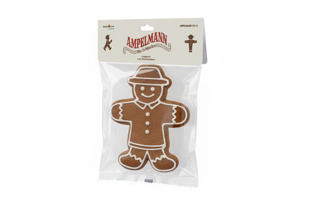 Klarsichtbeutel mit Ampelmann-Lebkuchen; oben cremefarbener Sattelreiter mit Logo, Piktogrammen und Euroloch zur Hängung.